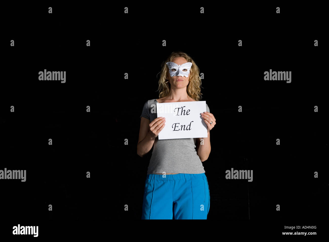 A woman holding a sign for 'The End' Stock Photo