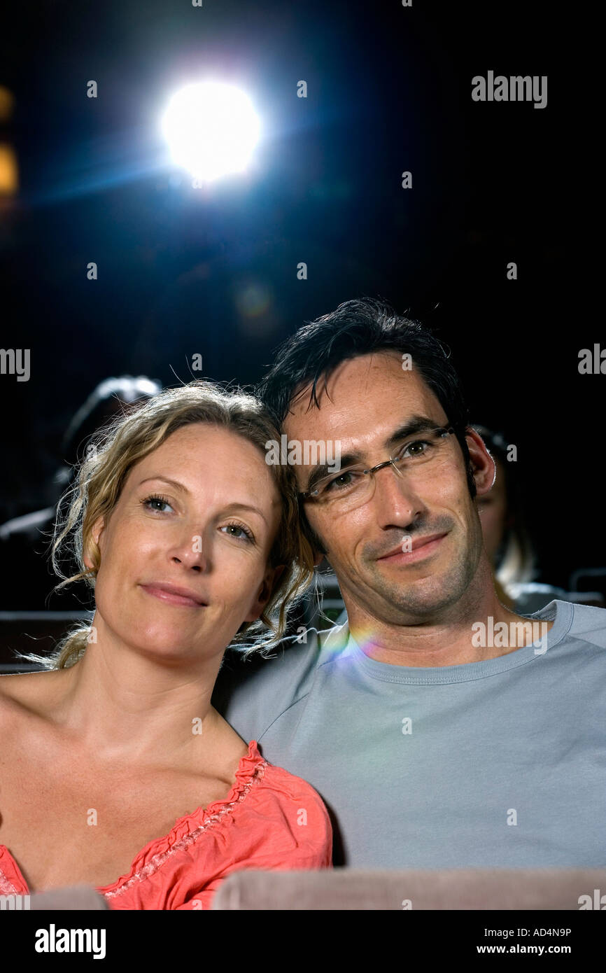 A mid adult couple sitting together in a movie theater Stock Photo