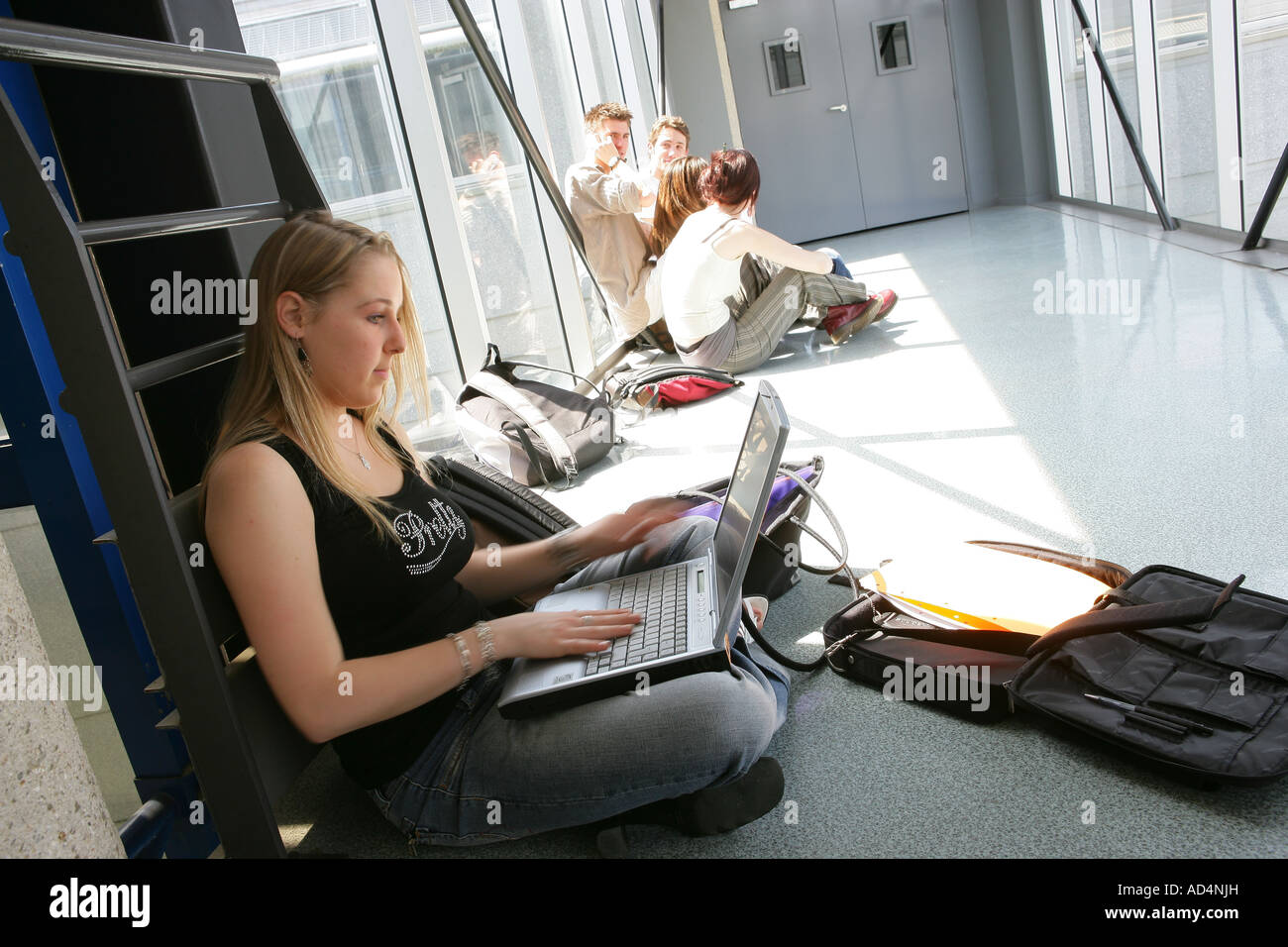 Students sitting on the floor Stock Photo - Alamy