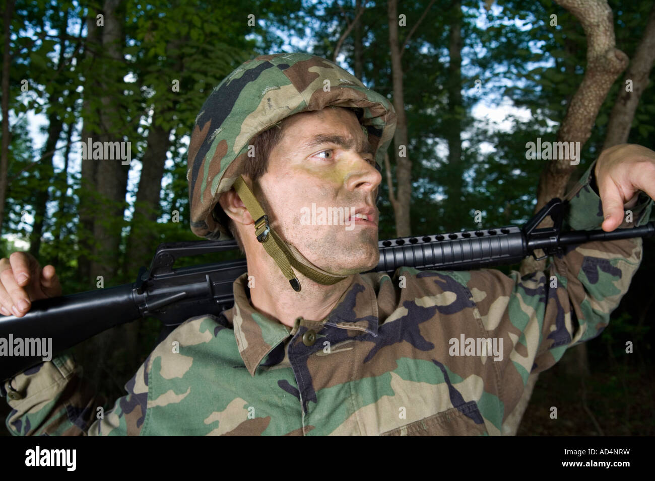 Soldier resting a gun across his shoulders Stock Photo