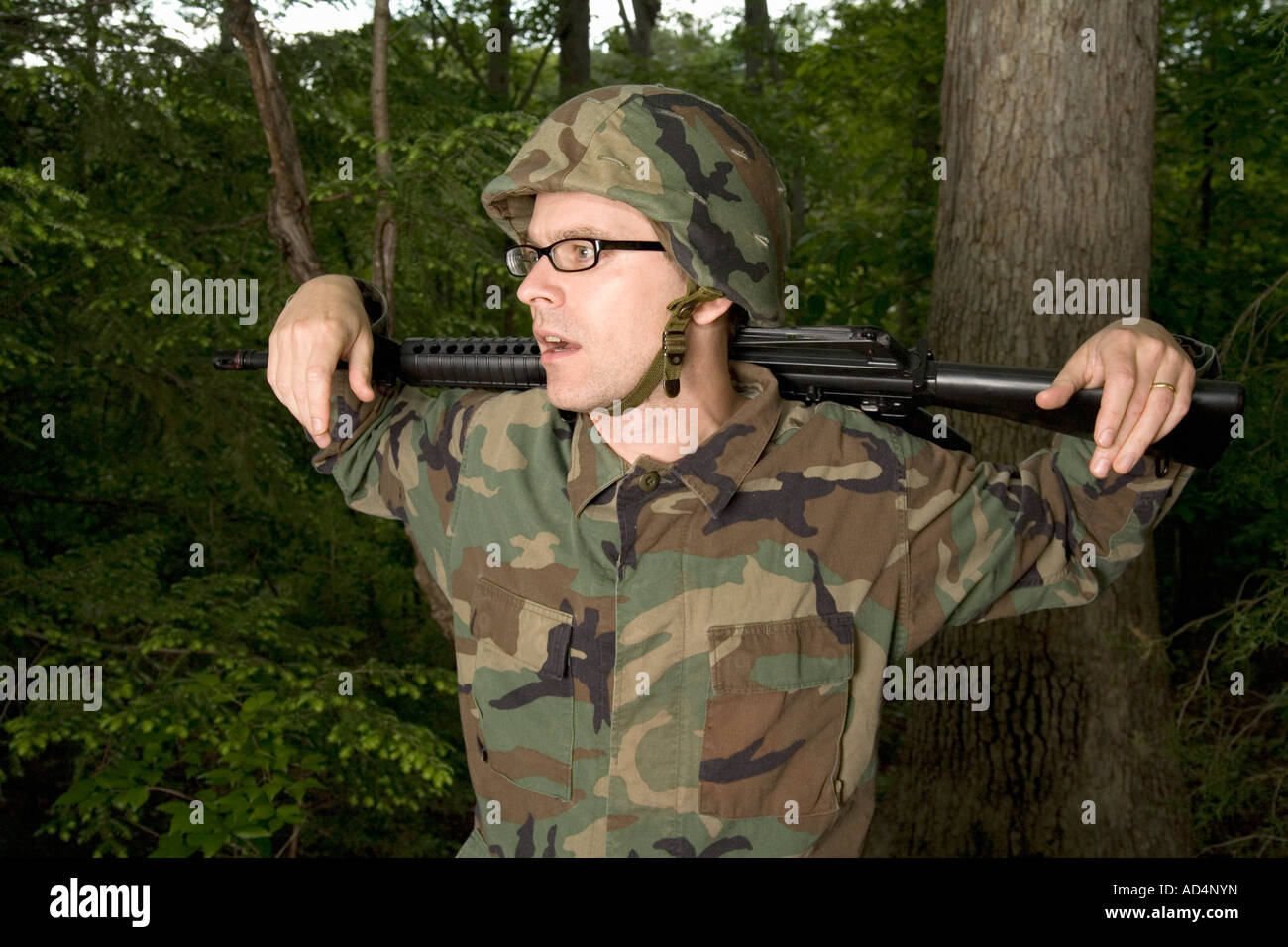 Soldier resting a gun across his shoulders Stock Photo