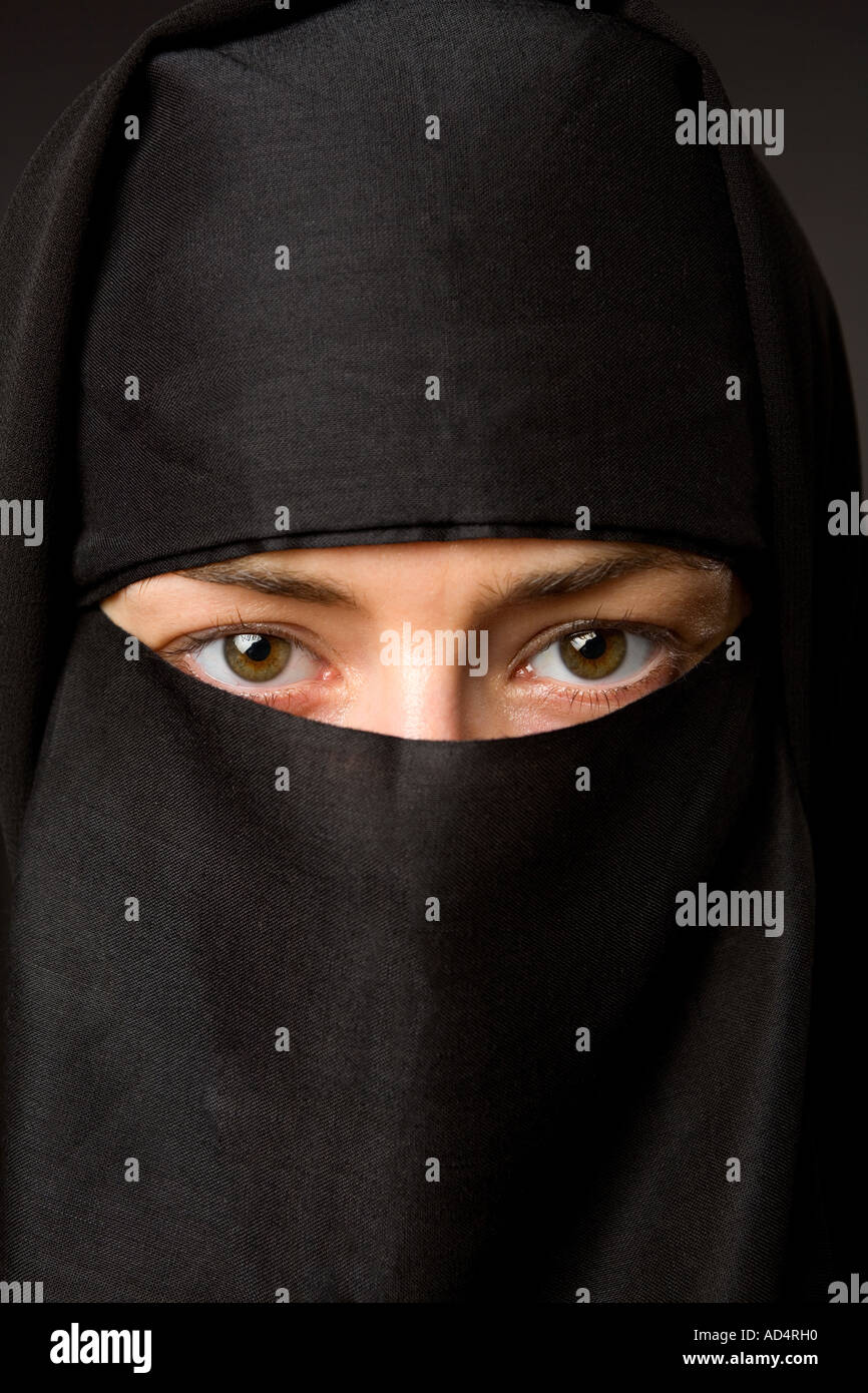 Close up head shot of a Muslim woman in a black hijab with eyes looking ...