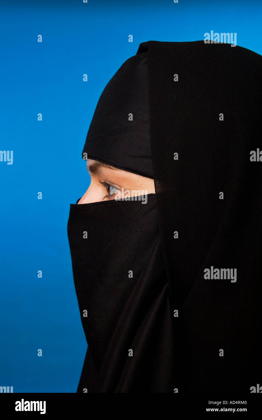Close up head shot of a Muslim woman in a black hijab with eyes looking ...