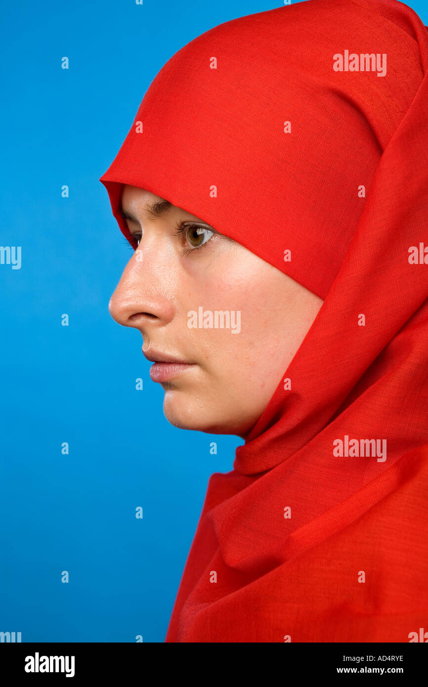 Close up profile head shot of a Muslim woman in a Red hijab with eyes ...