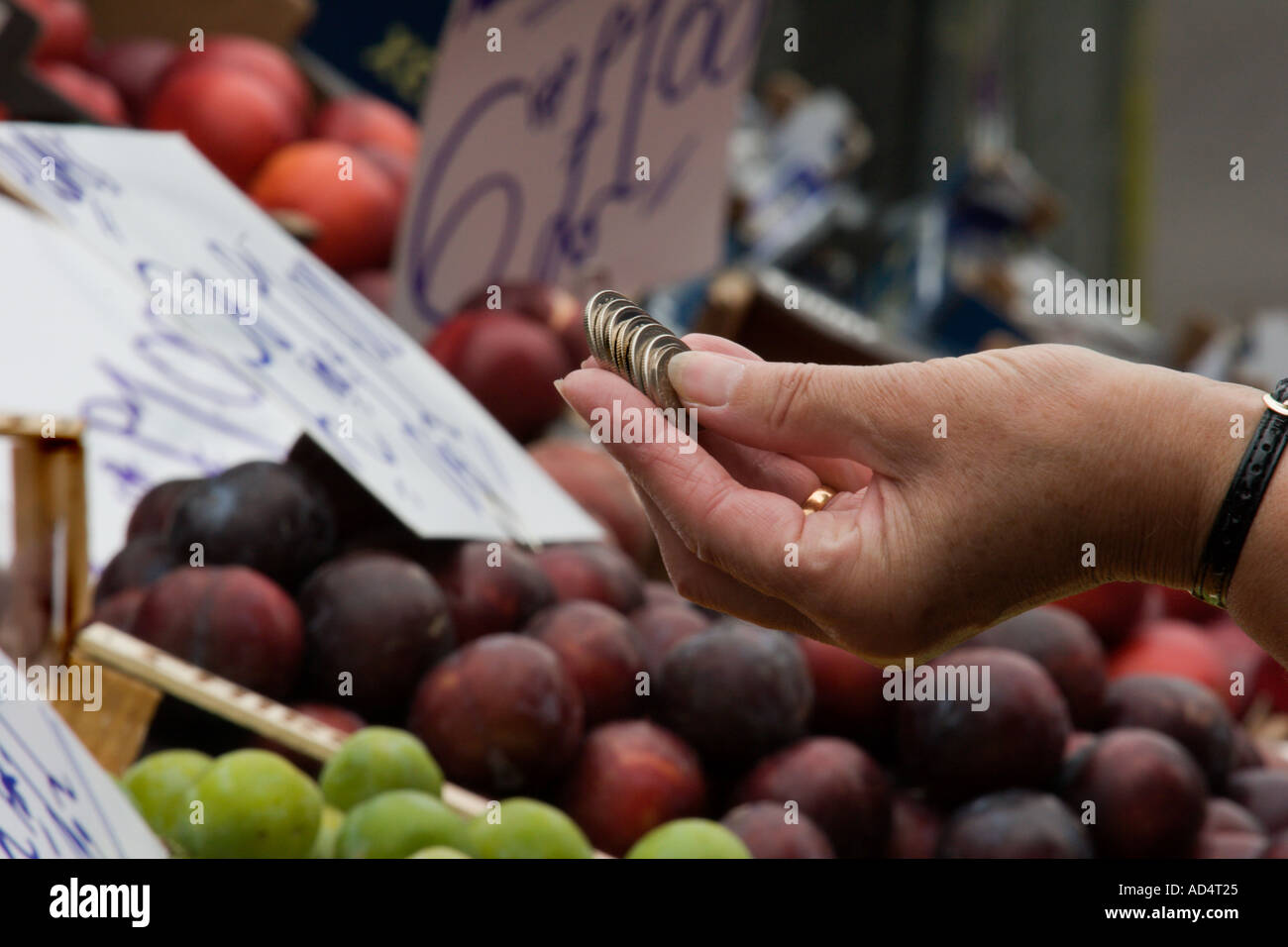 Buying fruit from a market stall in England Stock Photo