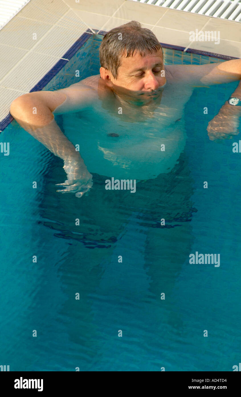 Odd looking man in a swimming pool Stock Photo