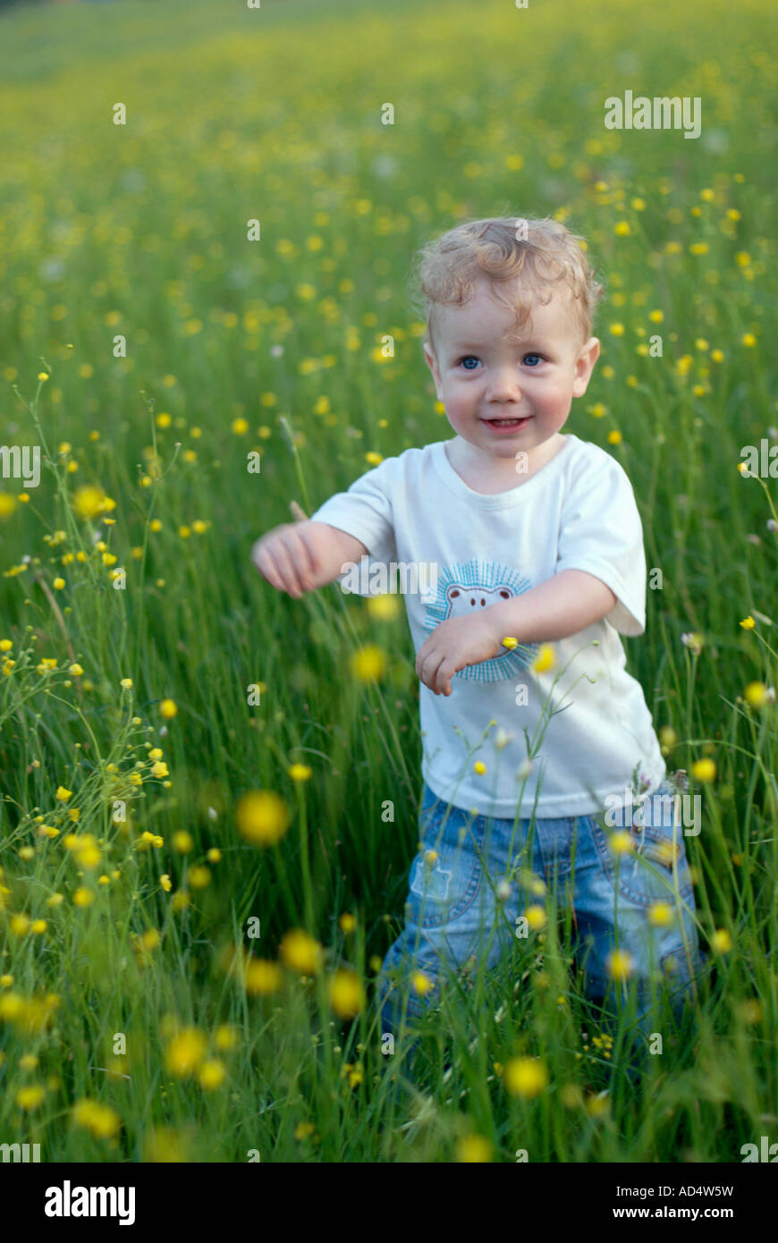 A young boy standing in a field Stock Photo - Alamy