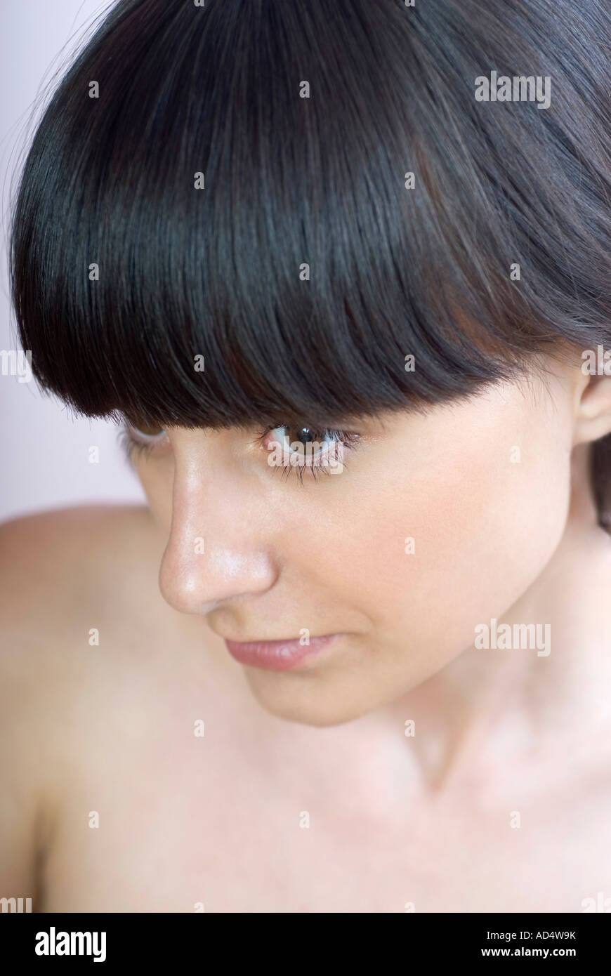 A young woman looking away Stock Photo - Alamy