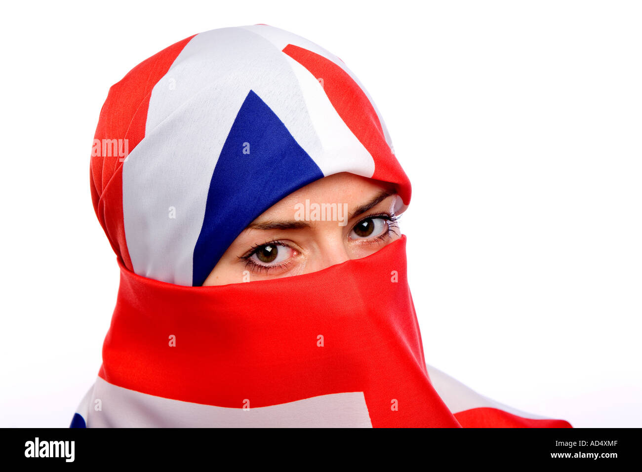 Muslim woman wearing a union jack flag as a  hijab burka with a white background Stock Photo