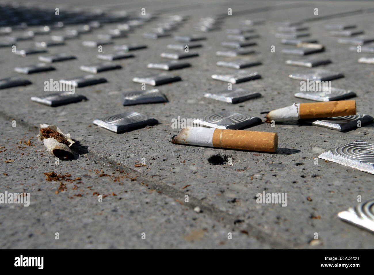 Cigarets thrown on the ground Stock Photo Alamy