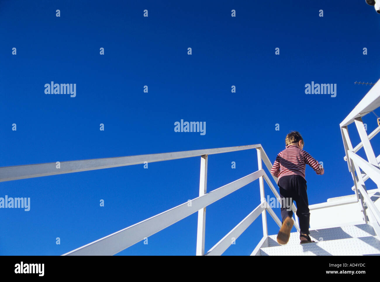 BOY RUNNING UP STAIRS Stock Photo Alamy