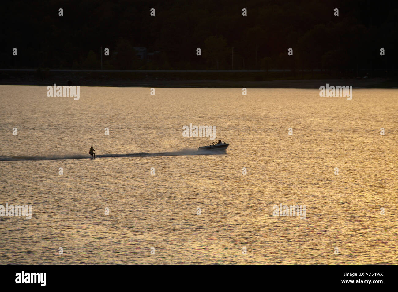 Watersking behind boat at sunset in Hinckley Reservoir in Herkimer County New York Stock Photo