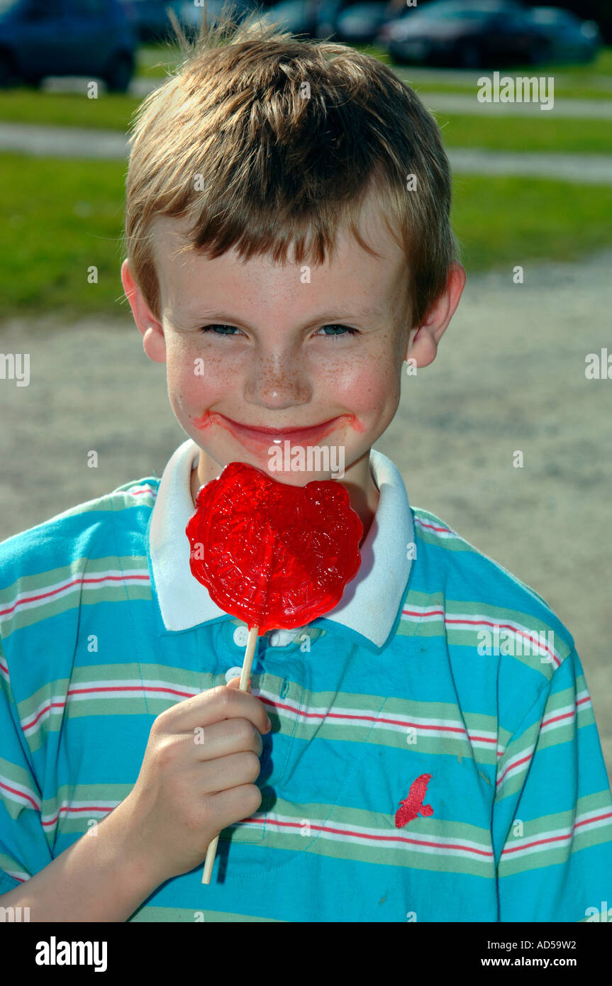 Boy Eating A Red Toffee Lolly Stock Photo