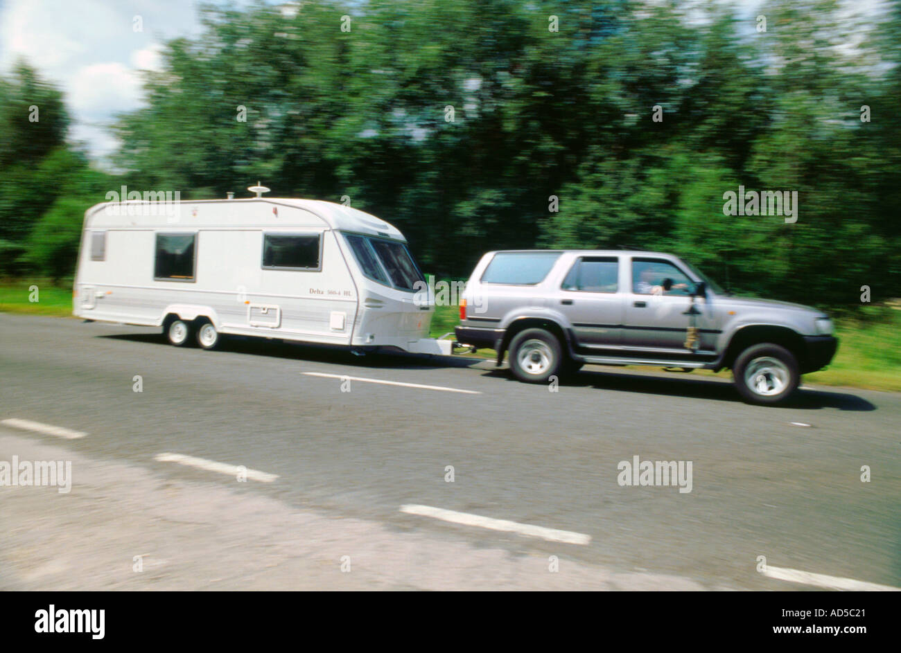 1995 Toyota Landcruiser towing large caravan at speed Stock Photo
