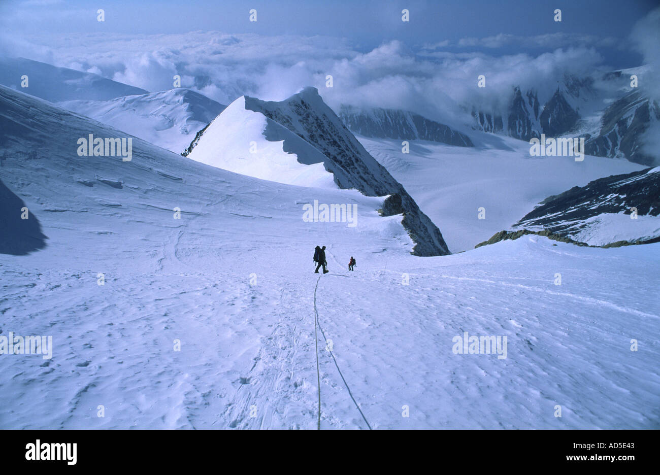 Mountaineers descending above a ridge on the West Buttress route Denali ...