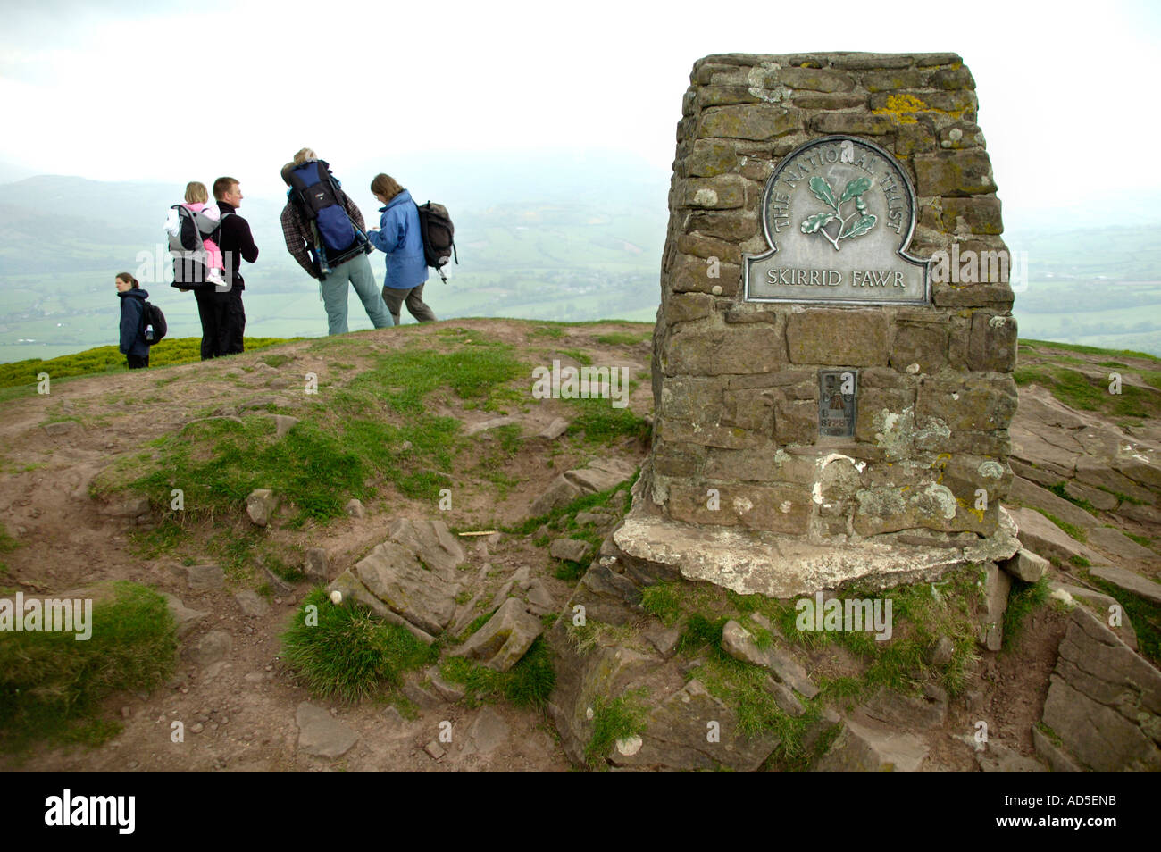 Family group of walkers on the summit of Skirrid Fawr mountain Abergavenny Monmouthshire South Wales UK Stock Photo
