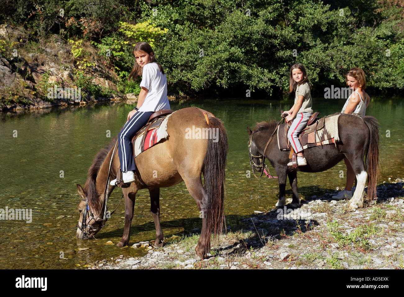 Girls riding horses Stock Photo - Alamy