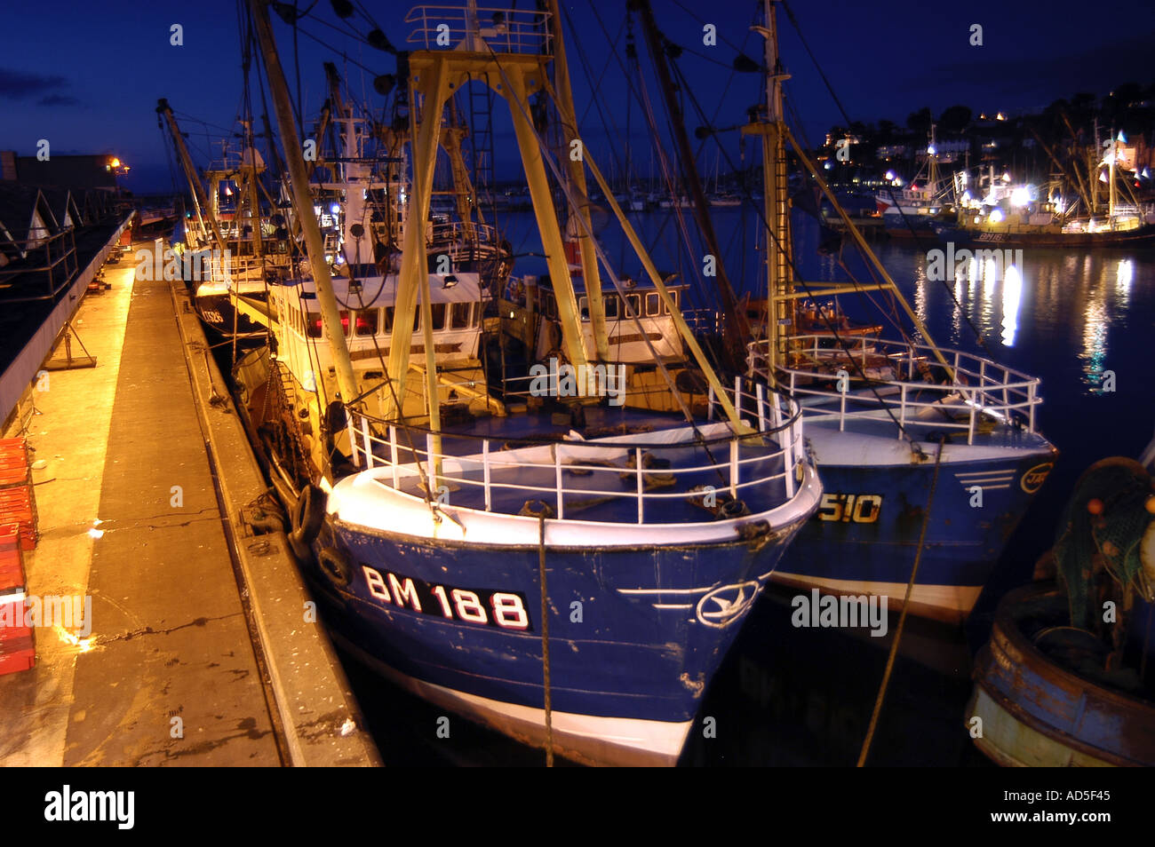 Fishing Trawlers moored at Brixham Harbour at Night Stock Photo