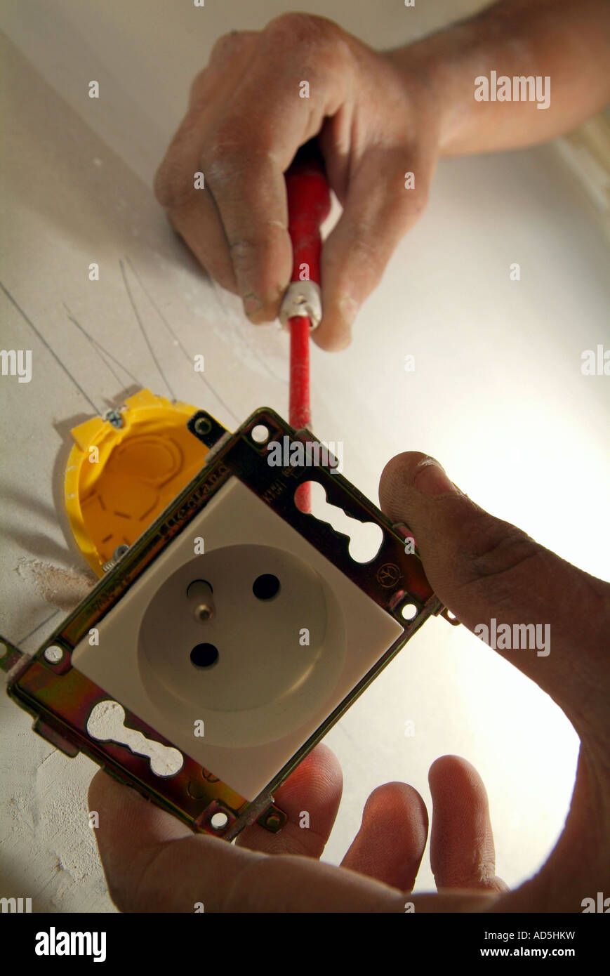 Electician installing a plug Stock Photo - Alamy