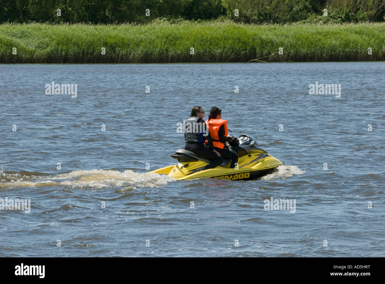 Two ladies on a jet ski Stock Photo