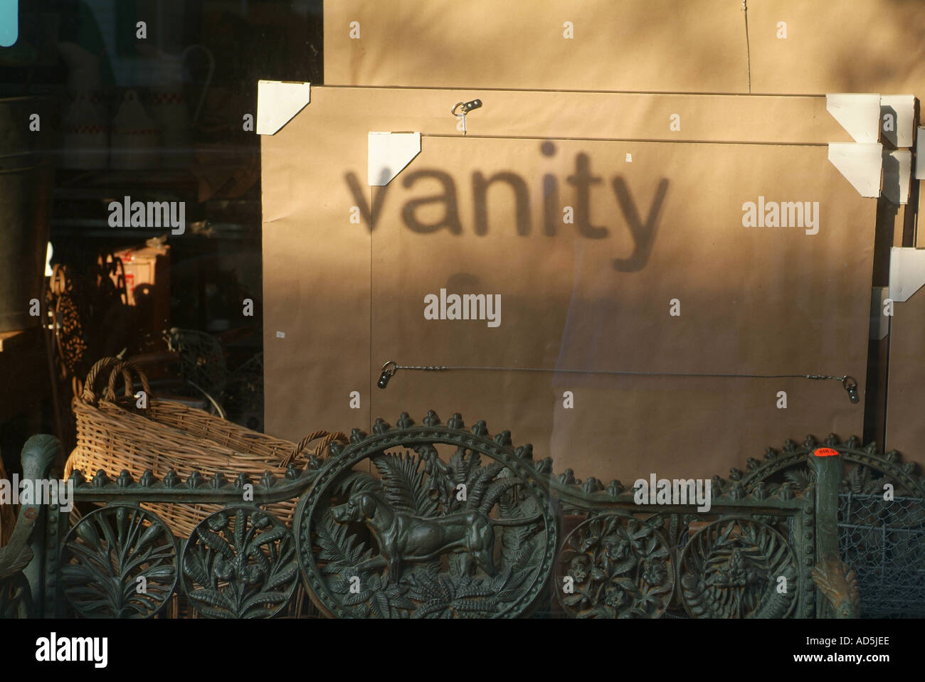 The word Vanity as a shadow in a store window with reflections Stock