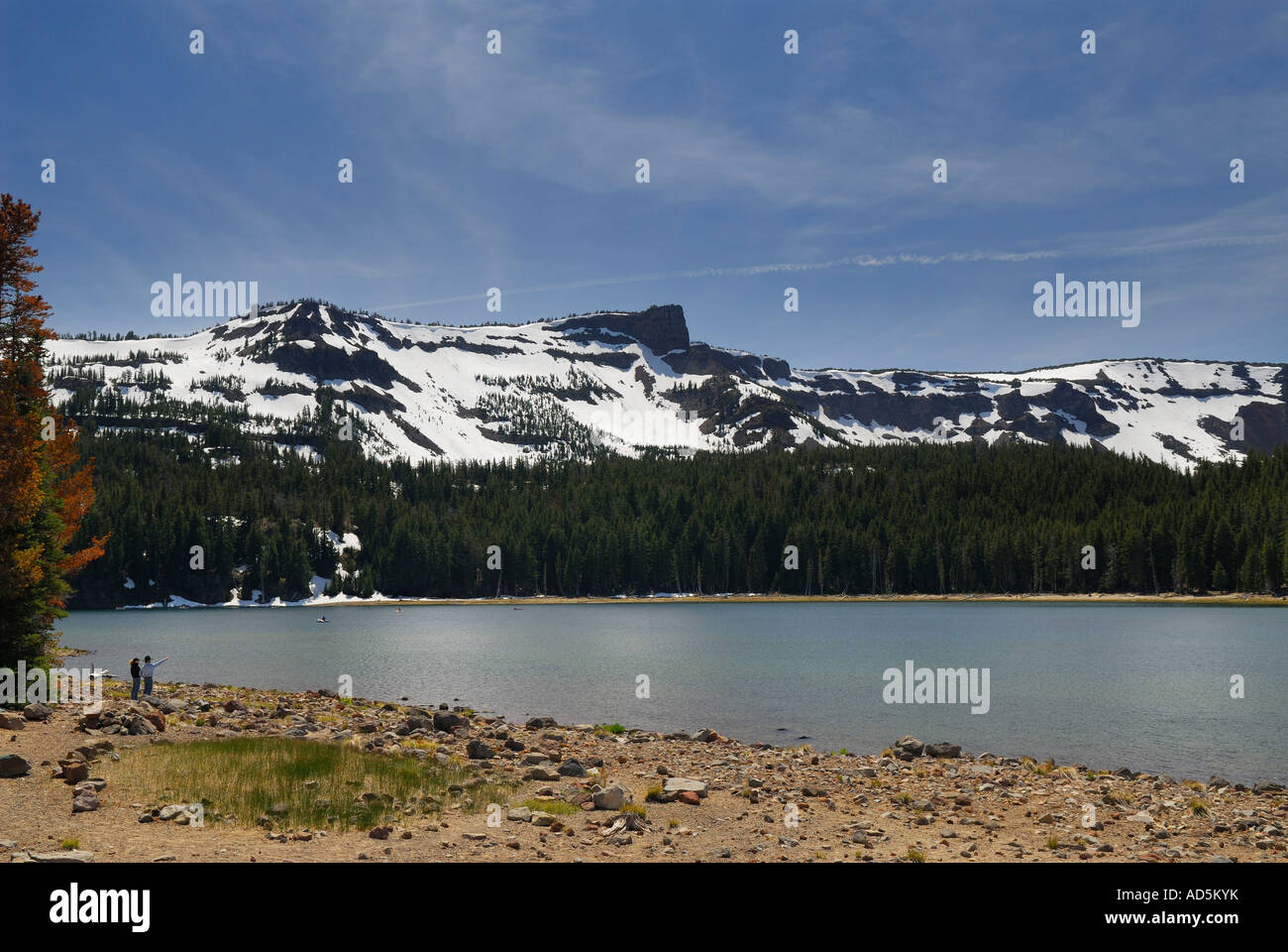Visitors to Three Creek Lake along snow capped Broken Top volcanic mountain Deschutes National Forest Bend Oregon USA Stock Photo
