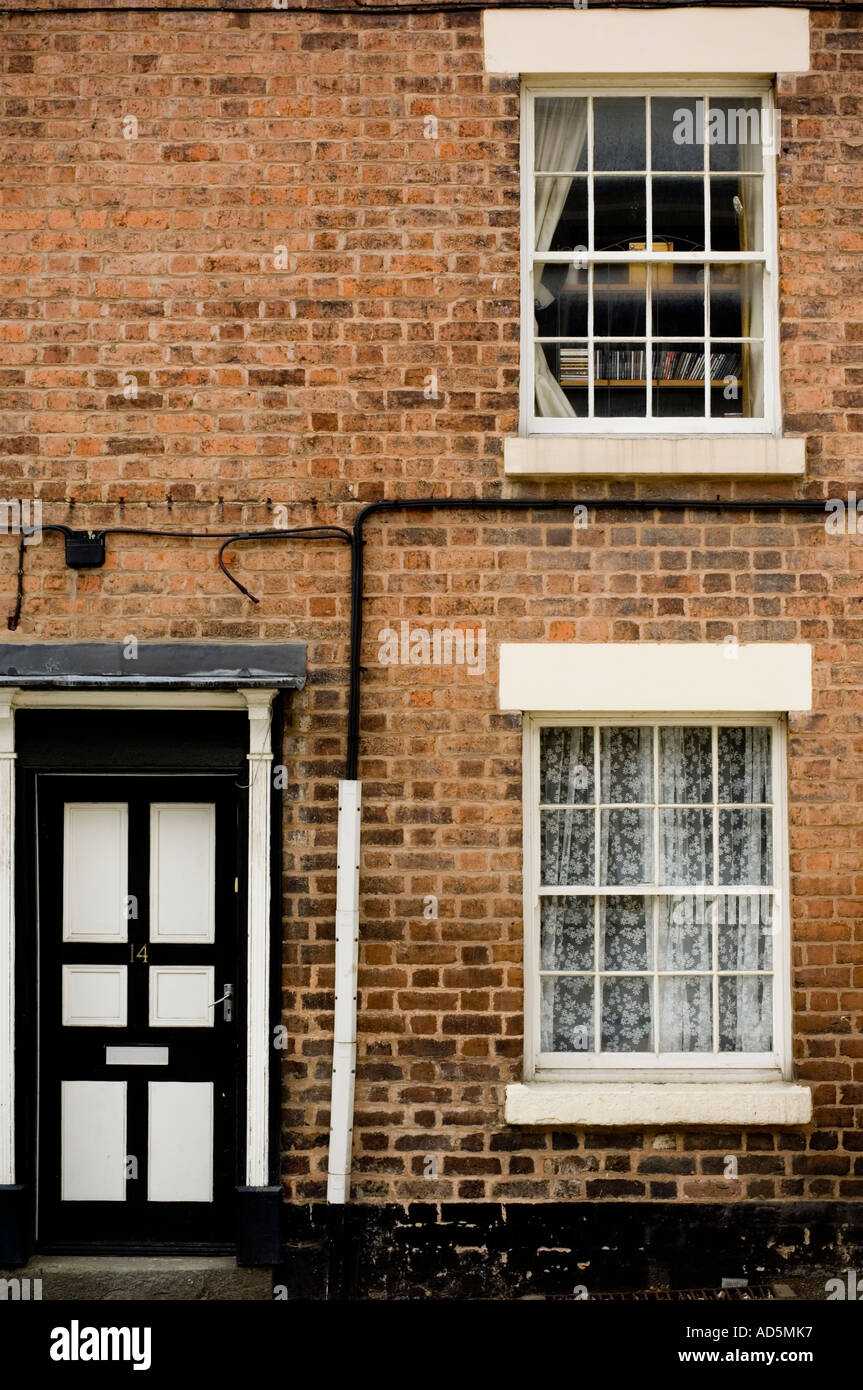 traditional brick built small Terraced house with original wooden sash