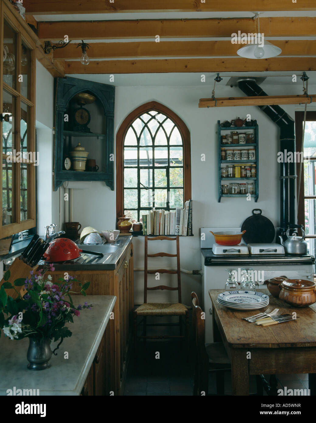 https://c8.alamy.com/comp/AD5WNR/antique-corner-cupboard-beside-arched-gothic-window-in-country-kitchen-AD5WNR.jpg