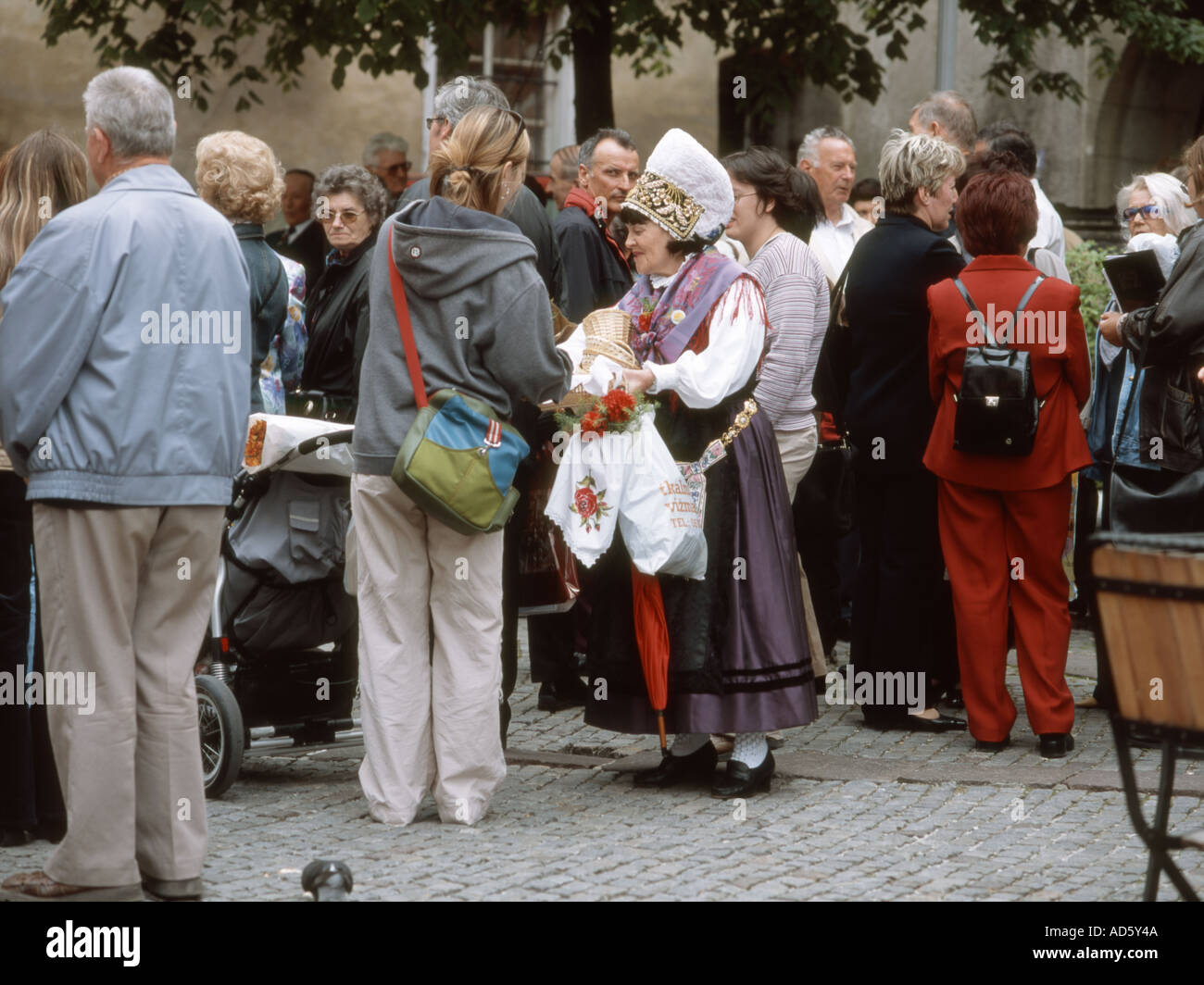 Ljubljana, Slovenia. Woman in traditional Slovene costume giving out