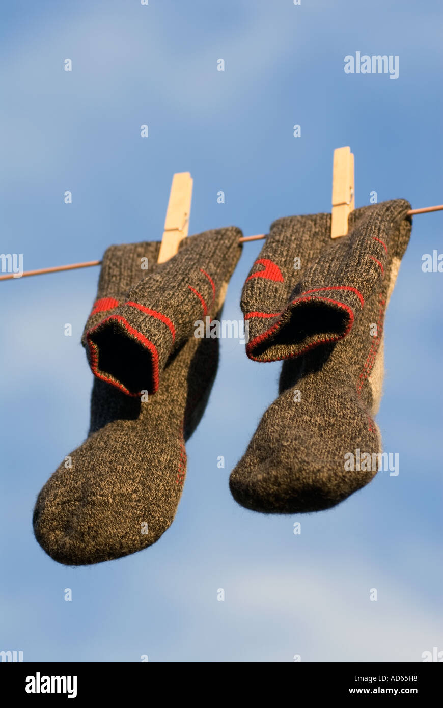 PICTURE CREDIT DOUG BLANE Concept A pair of clean grey gray and red wool walking socks hanging on a washing line to dry Stock Photo