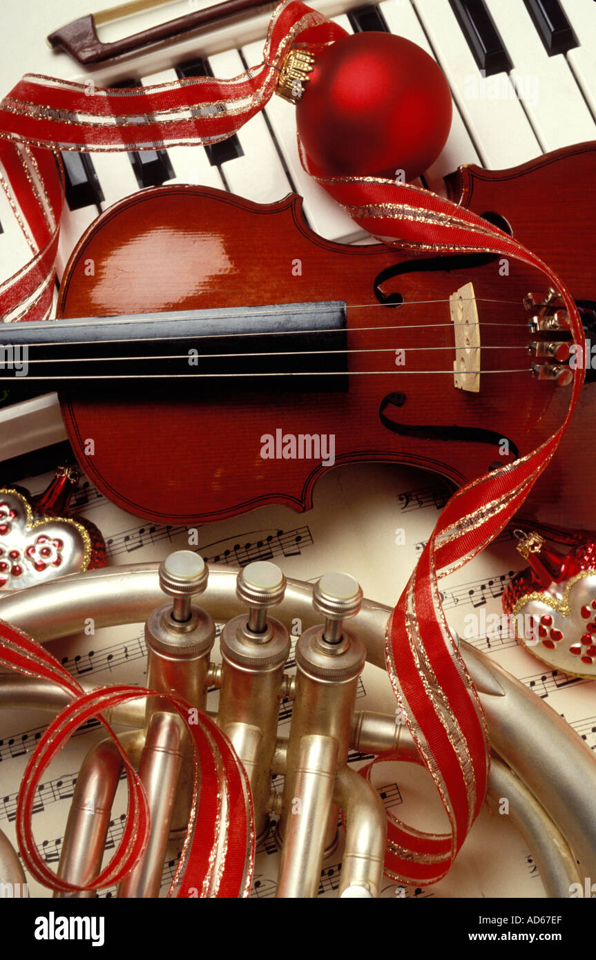 Christmas still life keyboard violin French horn ornaments and ribbon Stock Photo