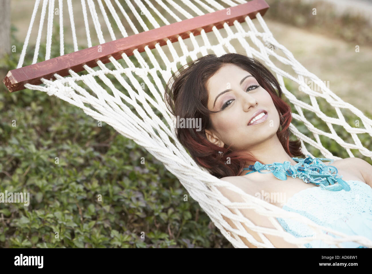 Portrait of a young woman lying in a hammock Stock Photo - Alamy