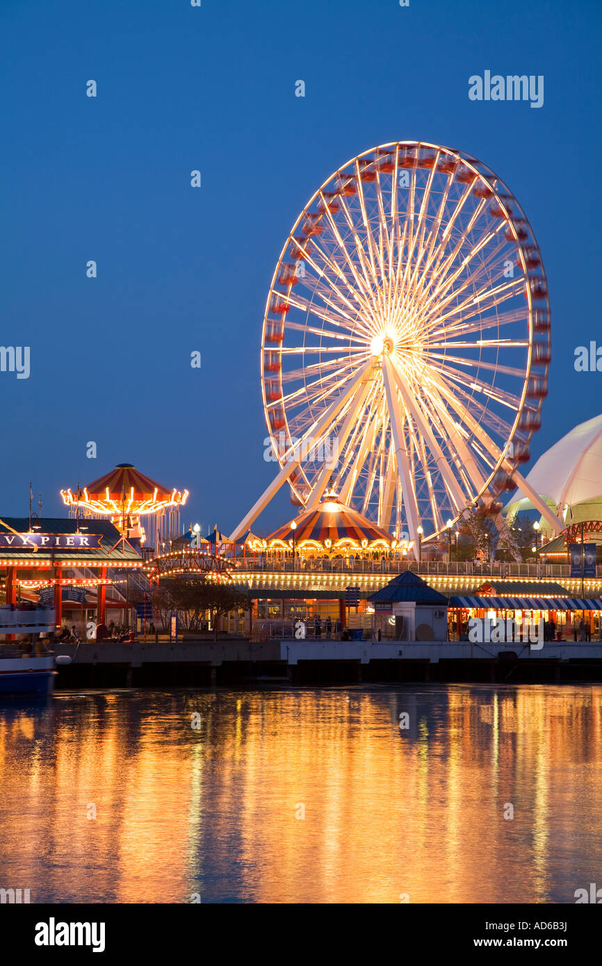 CHICAGO Illinois Ferris wheel and amusement rides at night Navy Pier reflection in water of Lake Michigan Stock Photo