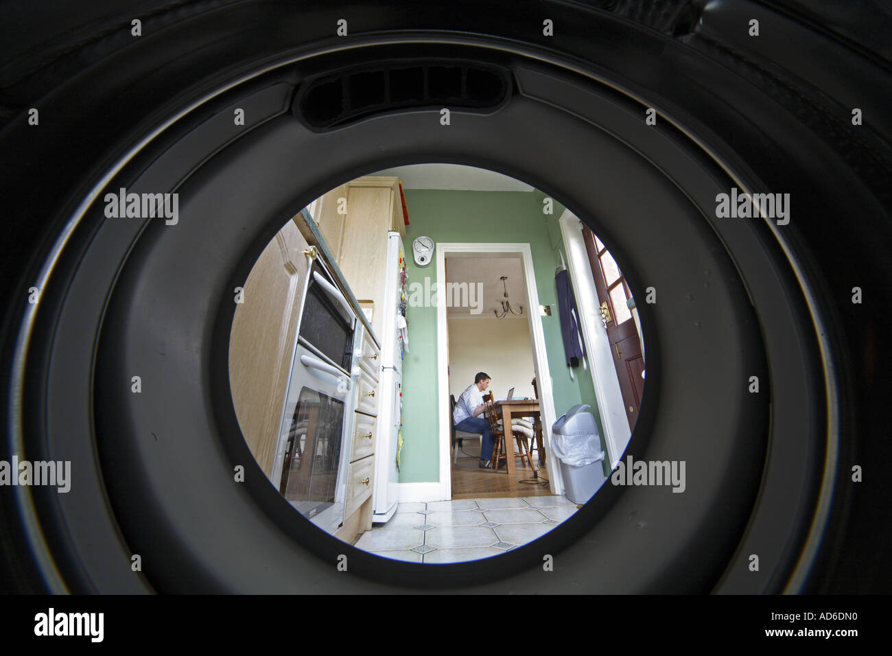 Unusual shot taken from inside a washing machine with the view outside of a kitchen (contd...) Stock Photo