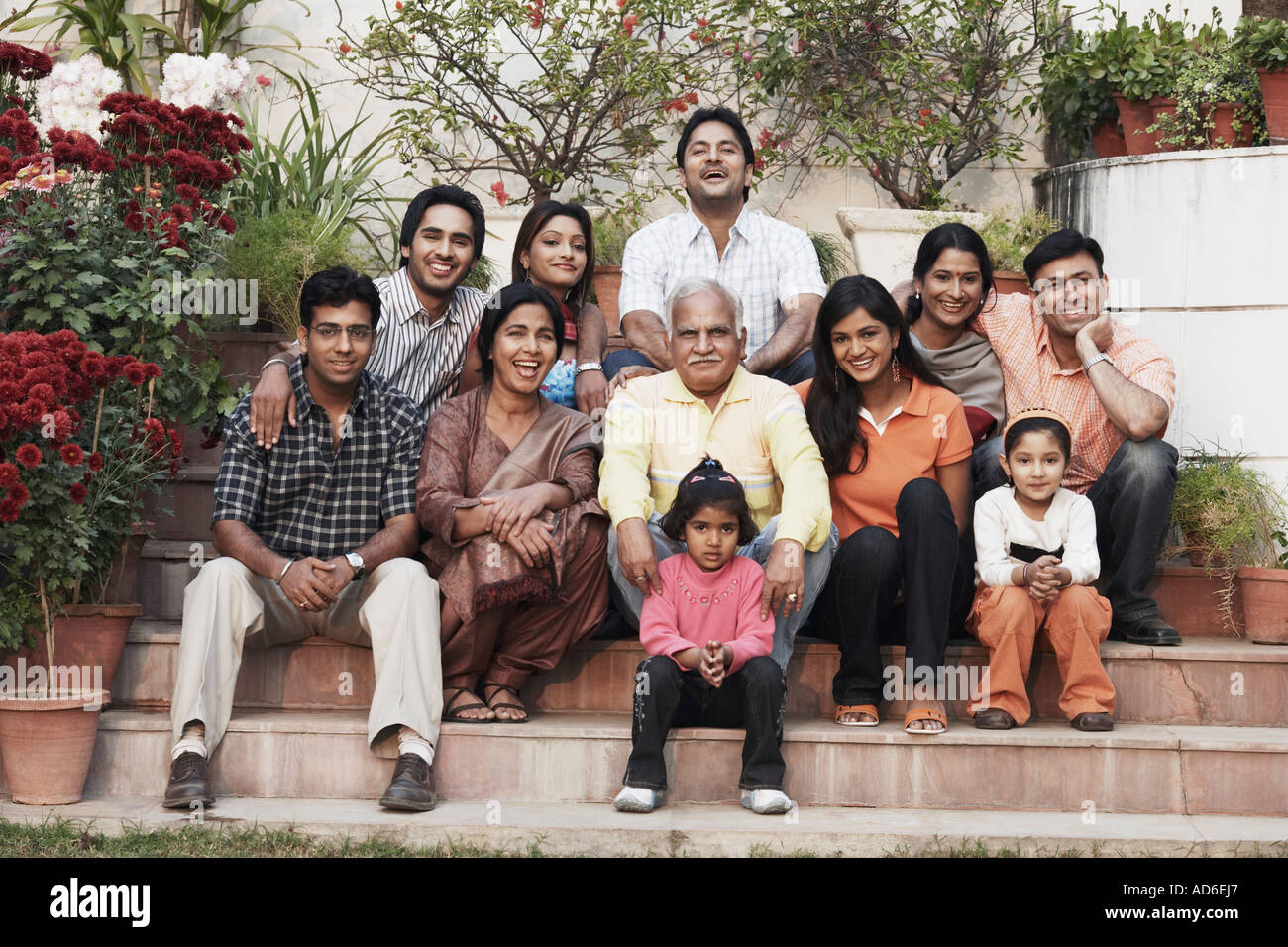 Portrait of a three generation family sitting on steps Stock Photo - Alamy