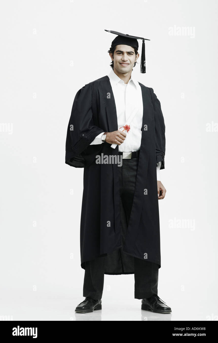 Portrait of a male graduate holding a diploma Stock Photo - Alamy
