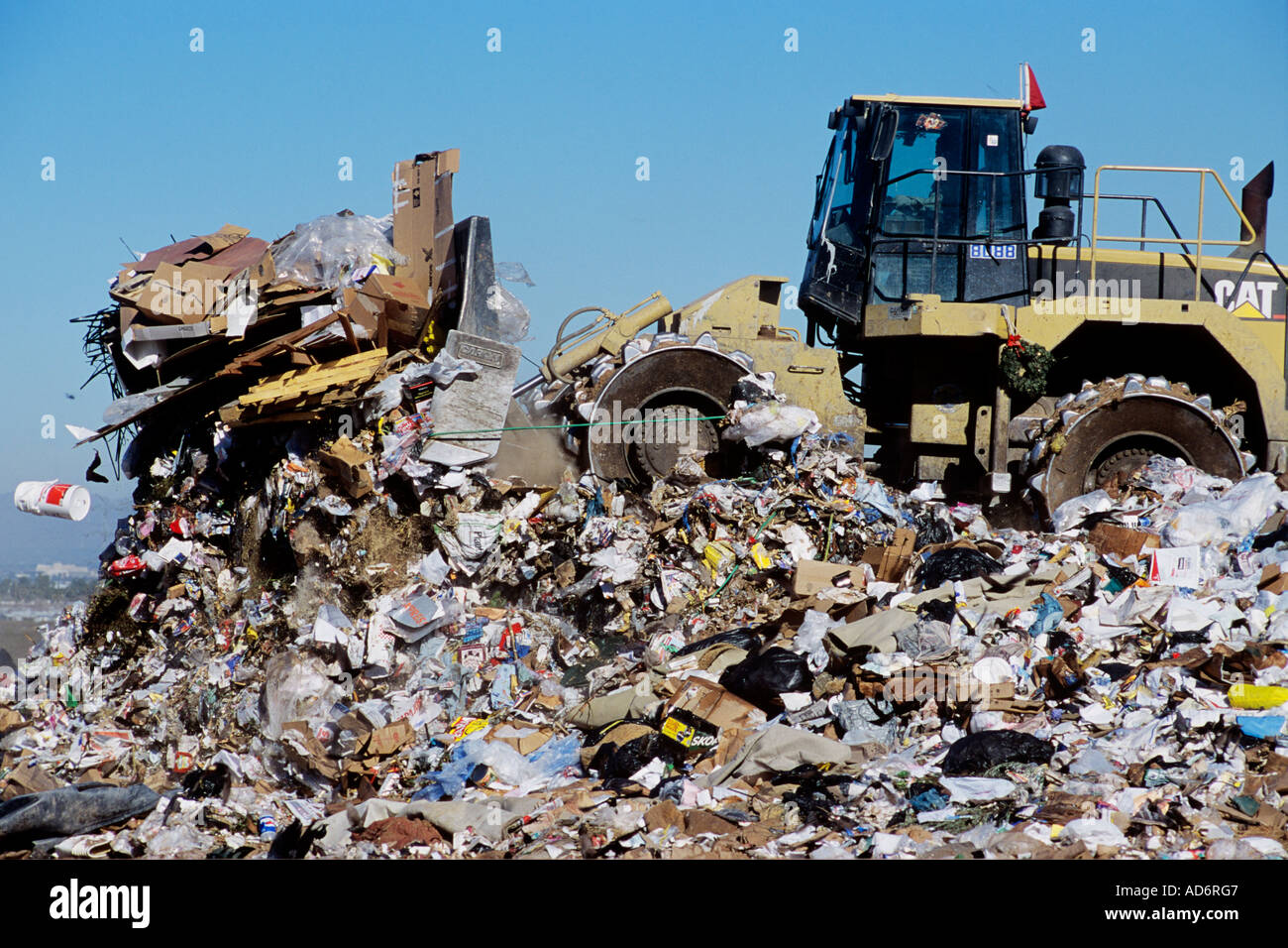 A large Cat  Bulldozer plows trash at a landfill. Stock Photo