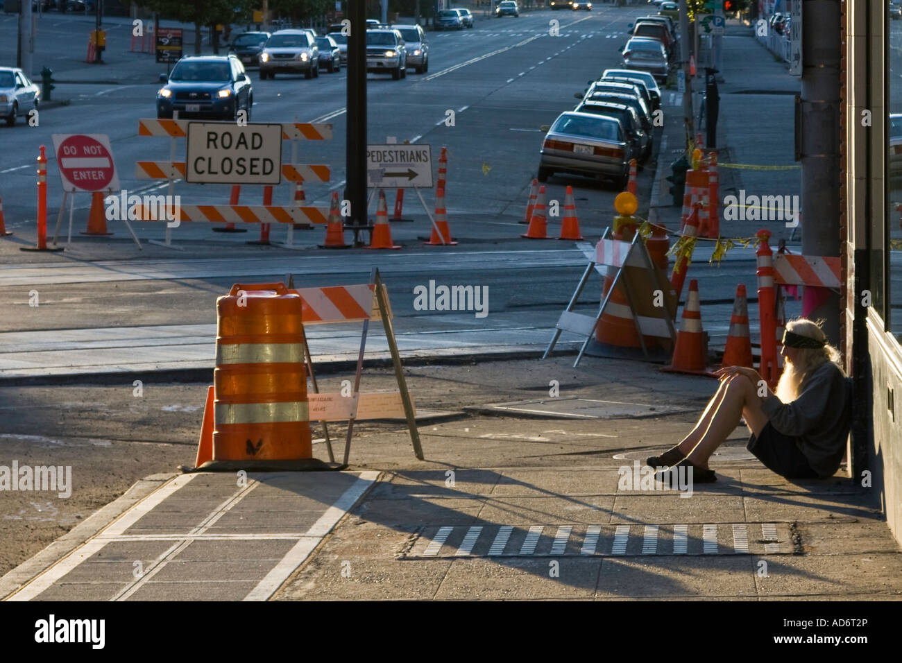 Homeless Man with long Beard Sitting on a Sidewalk Seattle WA USA Stock Photo