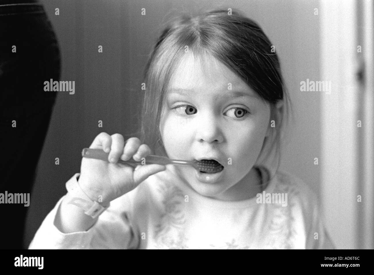 A child brushes her teeth Stock Photo
