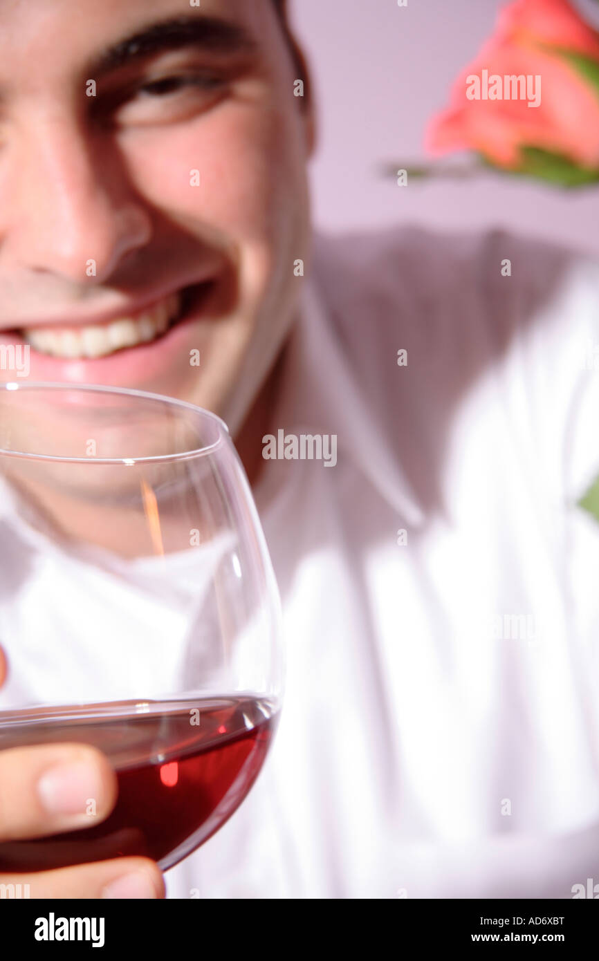 Young man drinking red wine, close up Stock Photo - Alamy