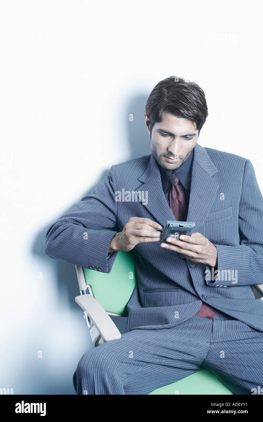 High angle view of a businessman using a personal data assistant Stock Photo