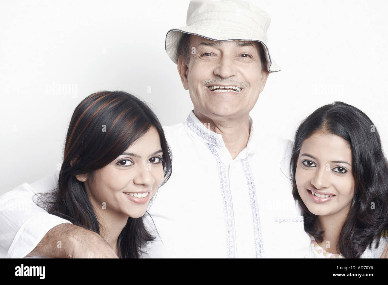 Portrait of a senior man with two young women Stock Photo - Alamy