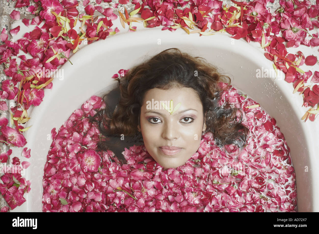 Woman in bathtub with flower petals hires stock photography and images