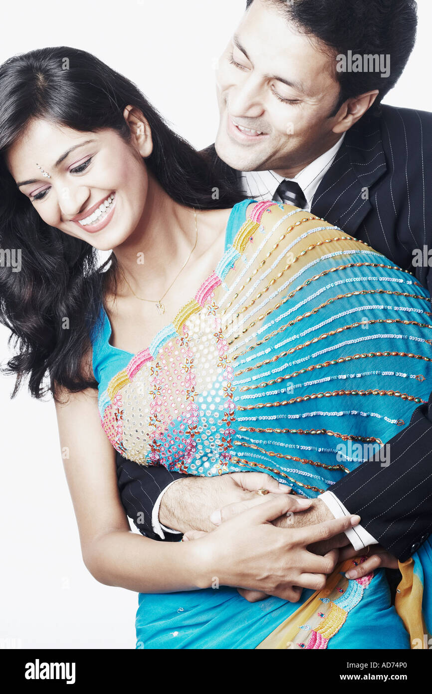 Young man embracing a young woman Stock Photo - Alamy