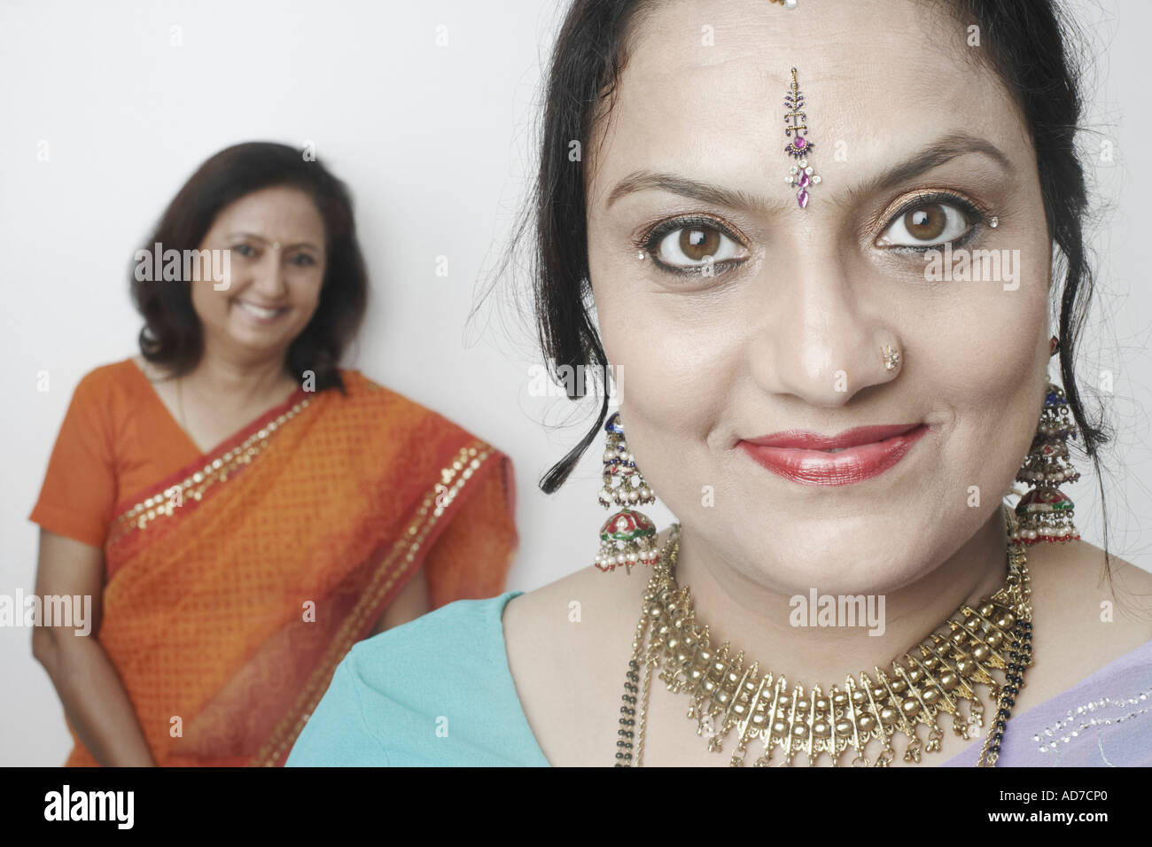 Portrait of a mature woman with another mature woman standing behind