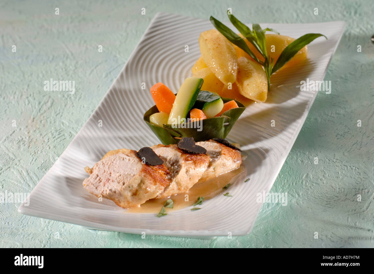 Coated roast chicken vegetables in a banana leaf and sweet potato Stock Photo