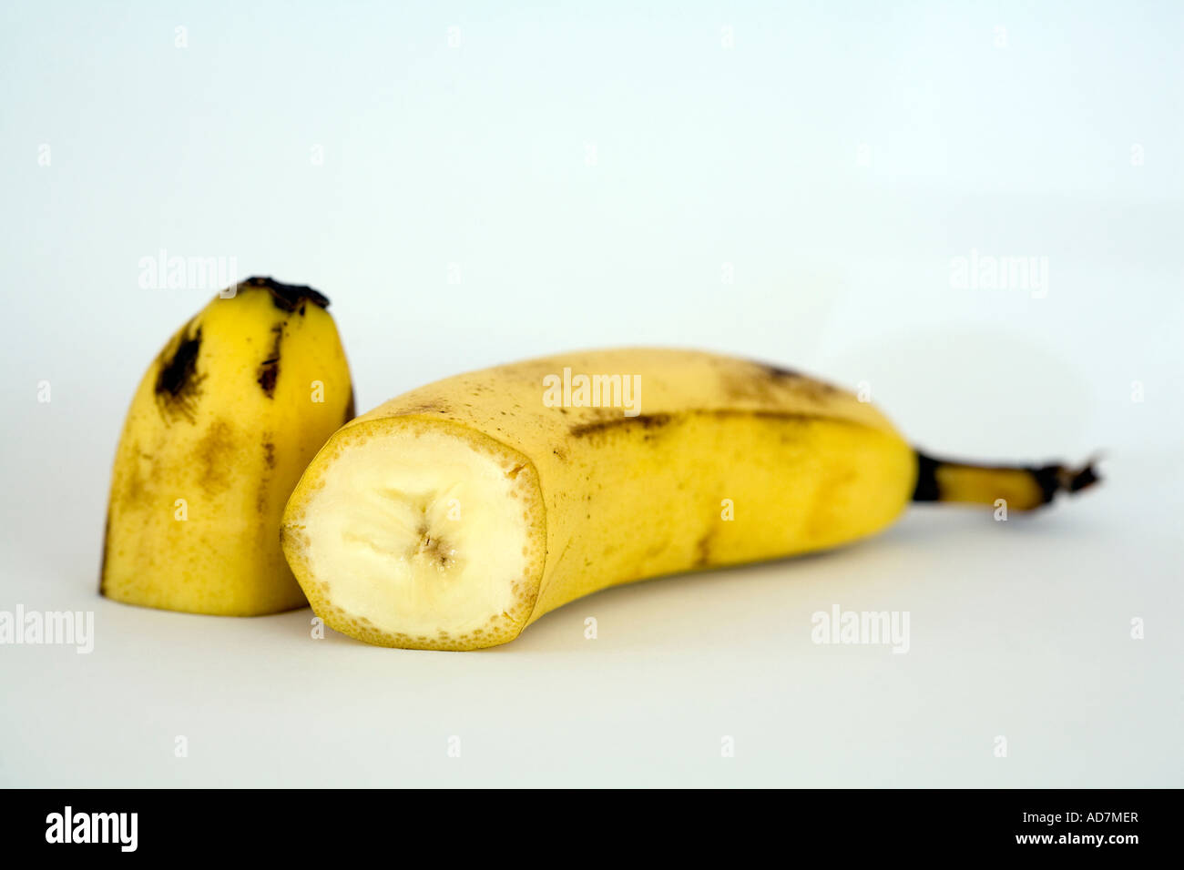 Banana cut in half on white background Stock Photo Alamy