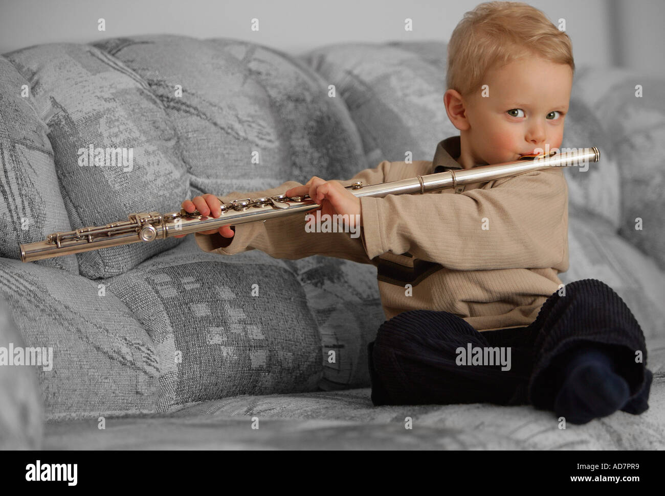 Young boy playing a flute Stock Photo Alamy
