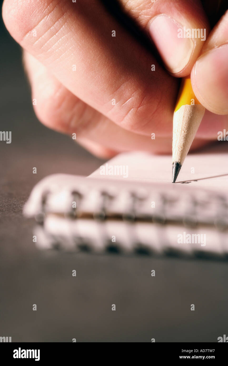 Closeup of person writing on paper Stock Photo