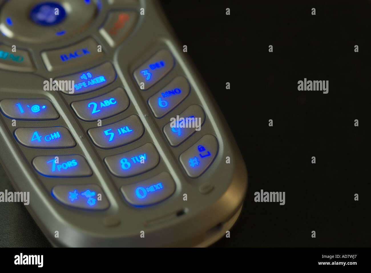 Close up of cellular phone with buttons lit Stock Photo